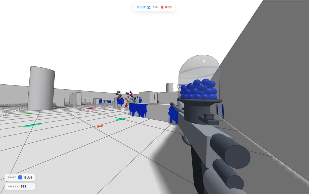First-person view along a gray wall in a white grid arena with blue paint drips and a loaded paintball gun